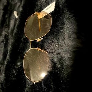 These are rose gold lined glasses with clear lenses and studs on the arms.